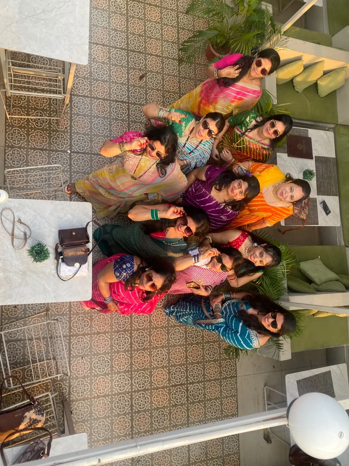Real kitty party guests posing on Chairish rooftop behind WTP Jaipur