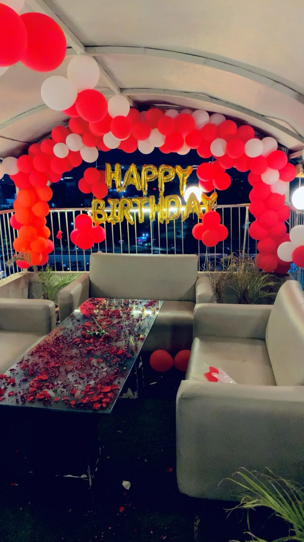 Birthday sofa seating with red and white balloon decoration at Chairish Cafe behind WTP Jaipur