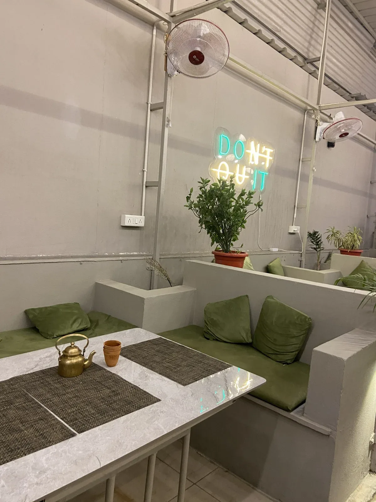 Private seating corner at Chairish Cafe with Do Not Quit wall sign
